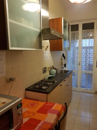a small kitchen with a stove and a sink at Room & Breakfast Santa Maria in Reggio Emilia