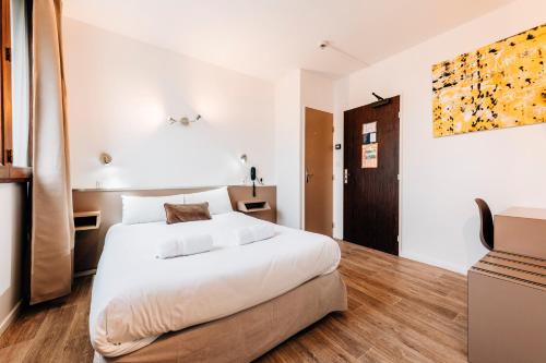 Postel nebo postele na pokoji v ubytování Hôtel Alizé