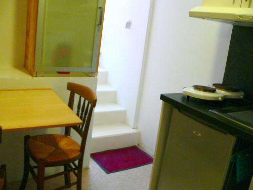 a kitchen with a table and a table and a table and chairs at Gite d'artiste 50m de la mer in Camaret-sur-Mer