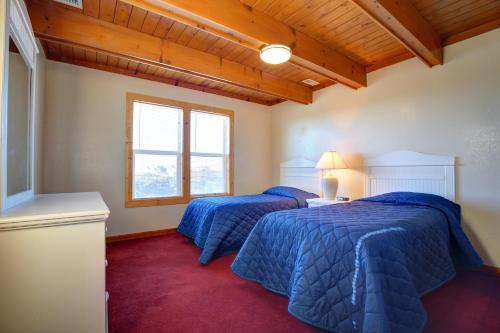 two beds in a room with blue comforter at Barrier Island Station in Duck
