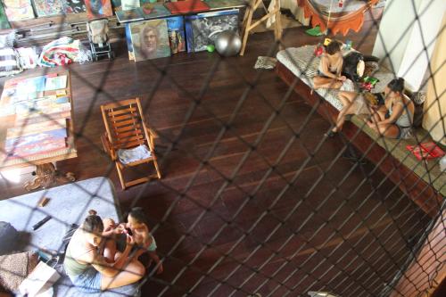 an overhead view of a group of people sitting at a bar at Fusion Guesthouse in Salvador