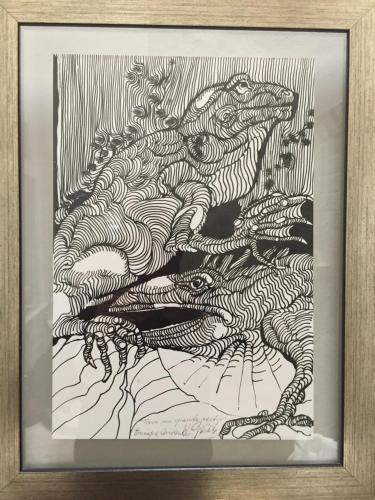 a framed drawing of three crocodiles in the water at Quinta Luna in Cholula