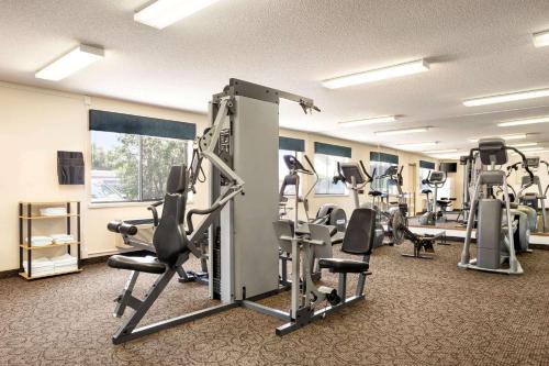 a gym with several tread machines in a room at Travelodge by Wyndham Morrill in Morrill