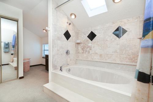 a white bath tub in a bathroom with a window at Resort Attractions in Willis