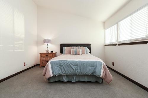 a white bedroom with a bed and a window at Resort Attractions in Willis