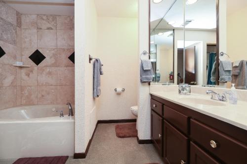 a bathroom with a tub and a toilet and a sink at Resort Attractions in Willis