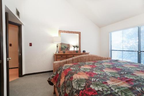 a bedroom with a bed and a mirror and a window at Resort Attractions in Willis