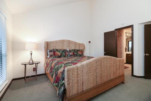 a bedroom with a wicker bed and a table with a lamp at Resort Attractions in Willis