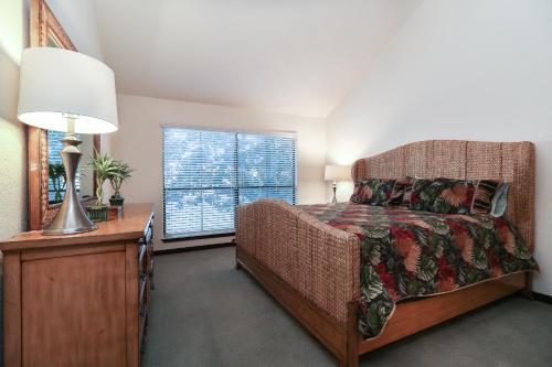 a bedroom with a bed and a lamp and a window at Resort Attractions in Willis