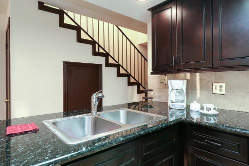 a kitchen with a sink and a staircase at Resort Attractions in Willis
