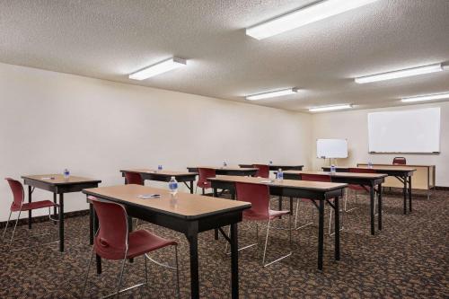 a classroom with tables and chairs and a whiteboard at Travelodge by Wyndham Morrill in Morrill