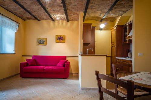 a living room with a red couch and a table at Borgo San Pietro in Agnone