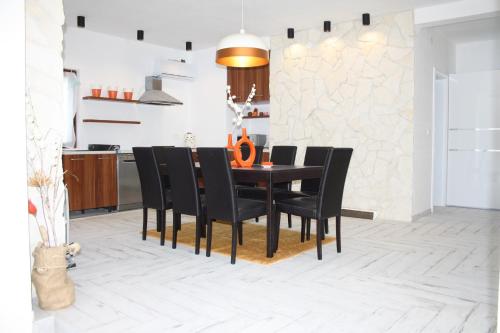 a dining room with a black table and black chairs at Villa Marko in Kras