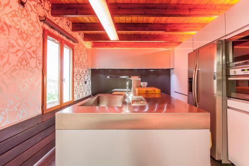 a kitchen with a sink and a refrigerator at Ca Carmela, casa con Encanto con Piscina "Parque Natural Sierra Calderona"cerca Garbi, Good Vives! in Valencia