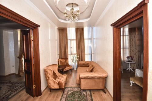 a living room with a couch and a table at Iberia Palace Hotel in Zugdidi