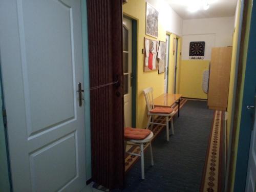 a hallway with chairs and a table and a door at Apartments České Středohoří in Teplice