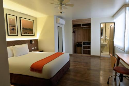 a hotel room with a bed and a bathroom at Casa Andina Standard Trujillo Plaza in Trujillo