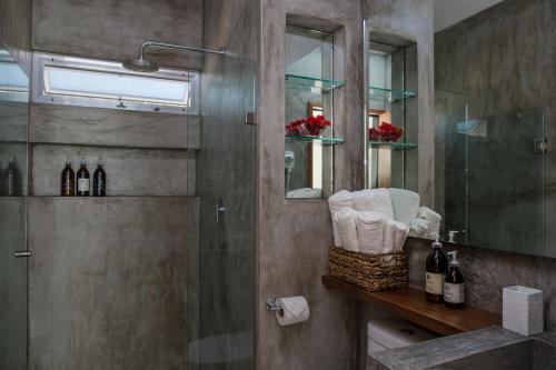 a bathroom with a shower and a glass shower door at Villas H2O in Tulum
