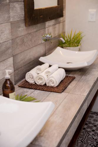 a bathroom with a sink and towels on a counter at Villas H2O in Tulum