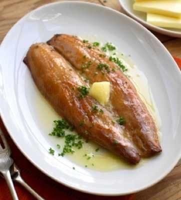 a white plate with two sausages and cheese on it at Kindale House in Helmsdale