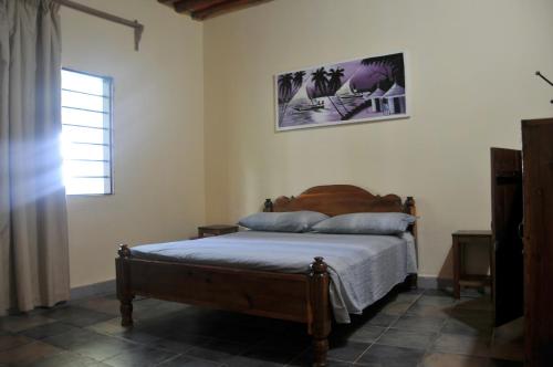 a bedroom with a bed and a window at Mama Njoe Lodge in Kiwengwa