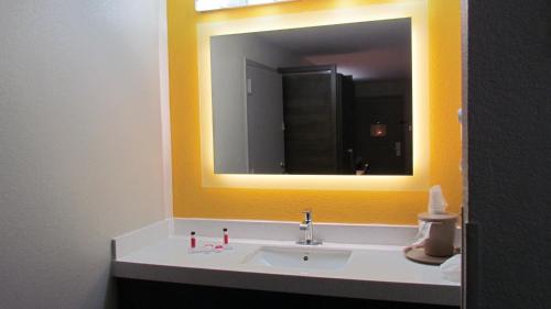 a bathroom with a sink and a mirror at Baymont by Wyndham Murfreesboro in Murfreesboro
