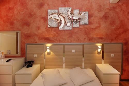 
a hotel room with a large bed and a painting on the wall at Socrates Hotel in Athens
