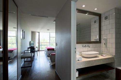 a bathroom with a sink and a large mirror at Palermo Soho Square in Buenos Aires