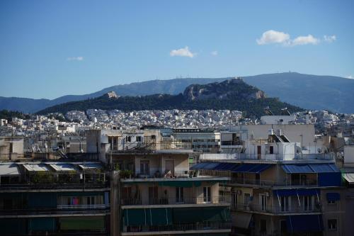 a city with buildings and mountains in the background at Socrates Hotel in Athens