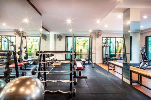 a gym with weights and exercise equipment in a hotel at Penyos Suite in Bangkok