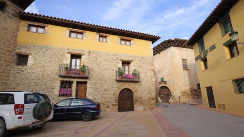 a car parked in front of a building at Apartamentos Rurales Casa del Tio Juan in Olocau del Rey