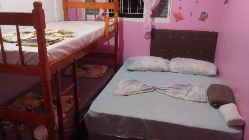 a bedroom with two bunk beds with towels on them at POUSADA FAMILIAR S.R. in São Gabriel