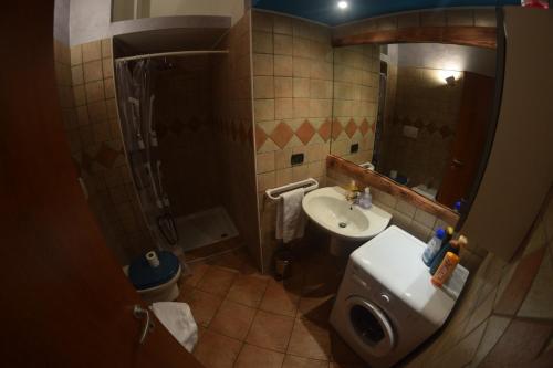 a small bathroom with a sink and a toilet at Marconi Rooms and Apartments in Verona