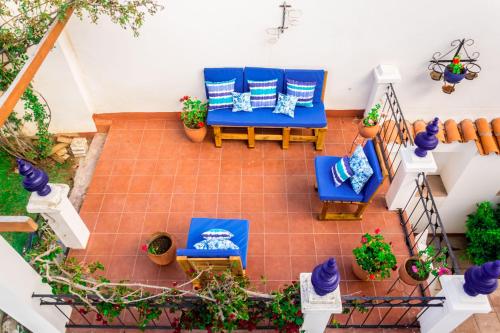 an overhead view of a patio with blue chairs and potted plants at El Jardin De Su Merced B&B in Sucre