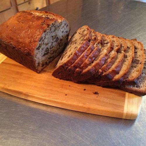 een brood op een snijplank met een stuk brood bij Seaway Manor B&B in Gananoque