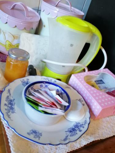 a table with a plate of utensils and a tea pot at Amor di Lavanda in Cingoli