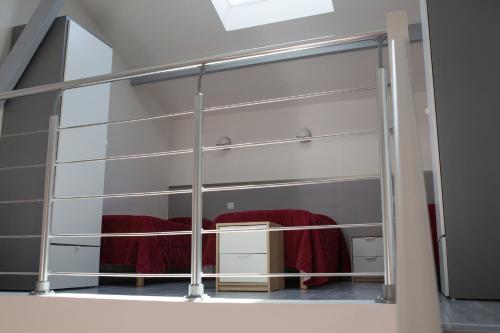 a mirror in a room with a red blanket at La Ferme Des Barmonts in Villejuif