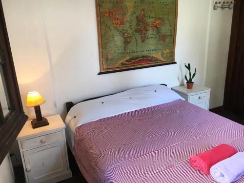 a bedroom with a bed and a map on the wall at Destino26 Hostel in Montevideo