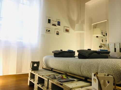 a bedroom with a bed and a wooden table at APPARTALOFT CENTRALE VR48 in Turin