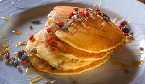 a stack of pancakes on a white plate at KAMARES Historic Boutique Hotel & Spa in Ioannina