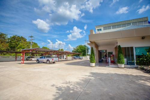 a gas station with a car parked in a parking lot at iRabbit Hotel in Prachin Buri