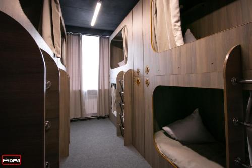 a room with bunk beds in a train at Nora Hostel in Yuzhno-Sakhalinsk