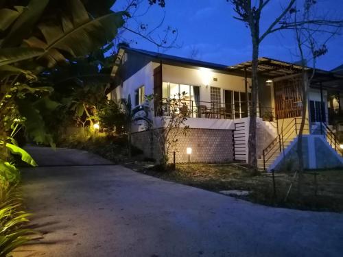 a house with a driveway at night at Twin Villa in Ban Muang Mai