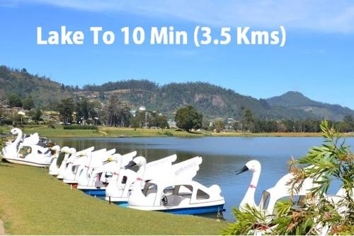 a row of white boats in the water at Mount View Cottage in Nuwara Eliya