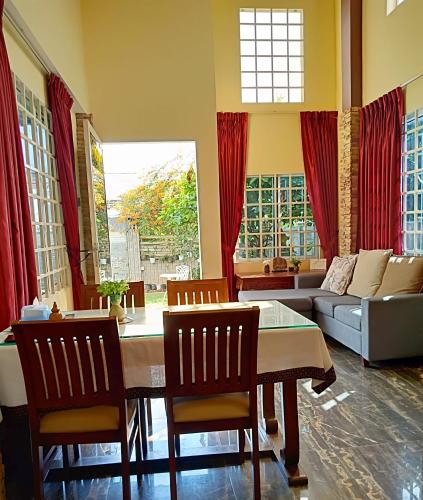 a living room with a table and chairs and a couch at KOL House in Phnom Penh