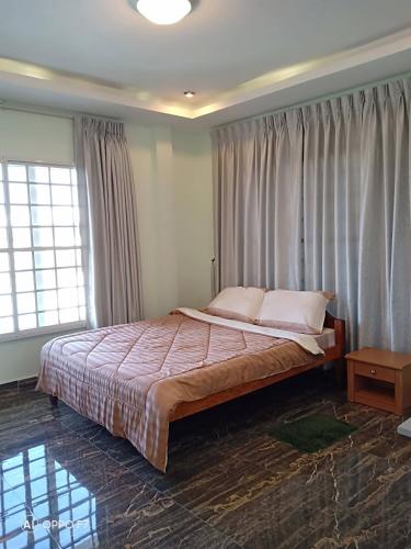 a bedroom with a large bed in a room at KOL House in Phnom Penh