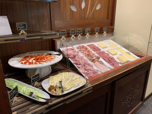a buffet with different types of meats and cheese at Hotel Bentheimer Hof in Bad Bentheim
