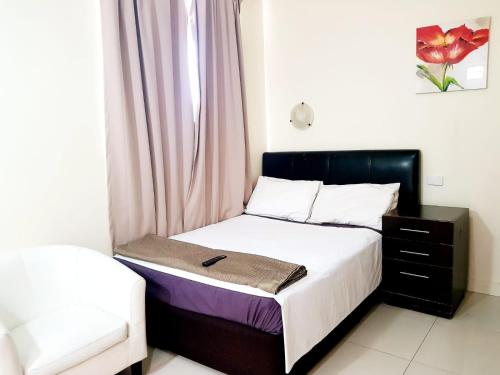 a small bedroom with a bed and a dresser at Perth City Motel in Perth
