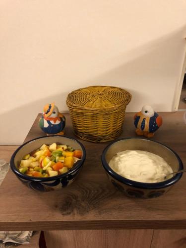 two bowls of food sitting on a wooden table at Hotel-Restaurant Gasthof zum Schützen in Baiersbronn