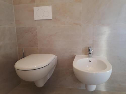 a bathroom with a toilet and a sink at Residence Viktoria in Castelrotto